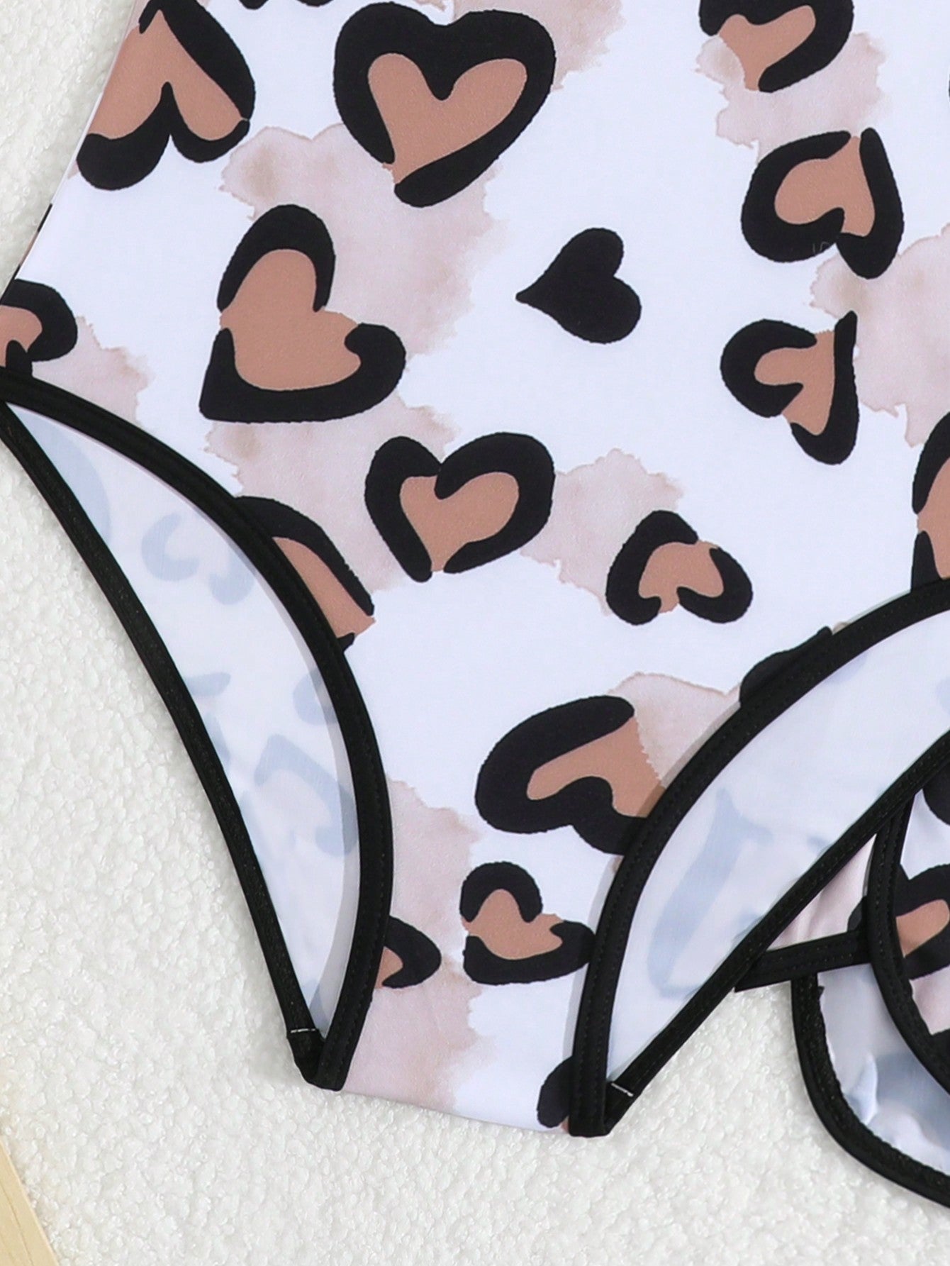 Girls 2-piece swimwear set featuring a butterfly print halter swimsuit top with contrast piping and separate mid-waist shorts; sleeveless, high-stretch, wireless design for beach and vacation wear.