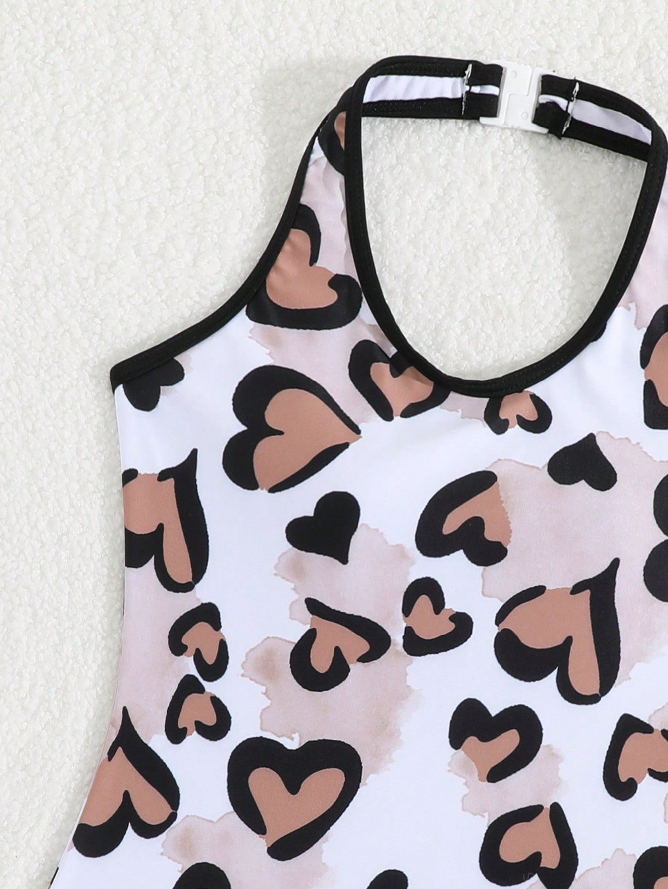Girls 2-piece swimwear set featuring a butterfly print halter swimsuit top with contrast piping and separate mid-waist shorts; sleeveless, high-stretch, wireless design for beach and vacation wear.