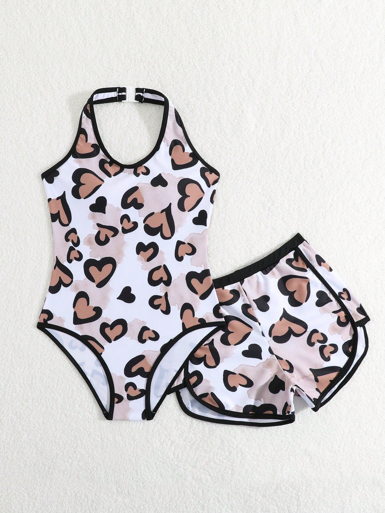 Girls 2-piece swimwear set featuring a butterfly print halter swimsuit top with contrast piping and separate mid-waist shorts; sleeveless, high-stretch, wireless design for beach and vacation wear.