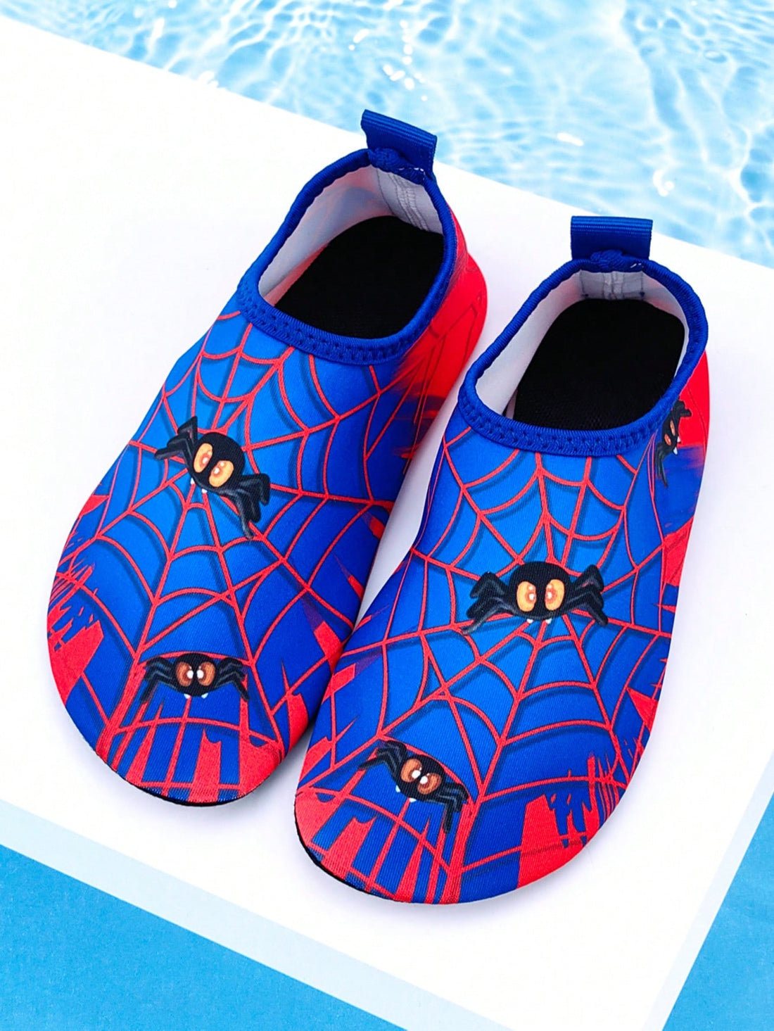 Red slip-on boys water shoes featuring a breathable fabric upper with contrast binding and a durable TPR outsole.