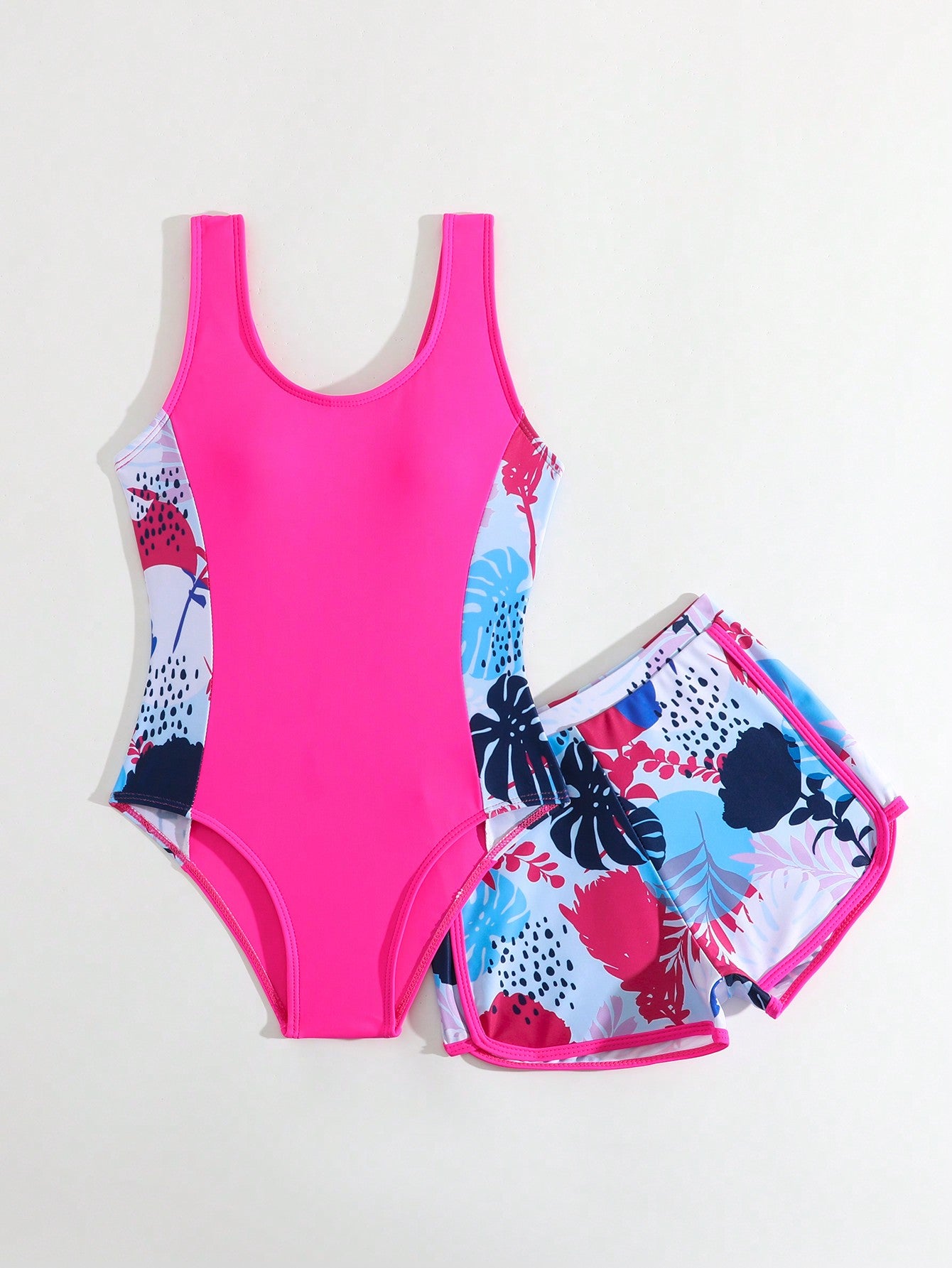 Tween girls 2-piece swimsuit set with a printed one-piece featuring ruffle trim, scoop neckline, cut-out detail, and matching shorts bottom.
