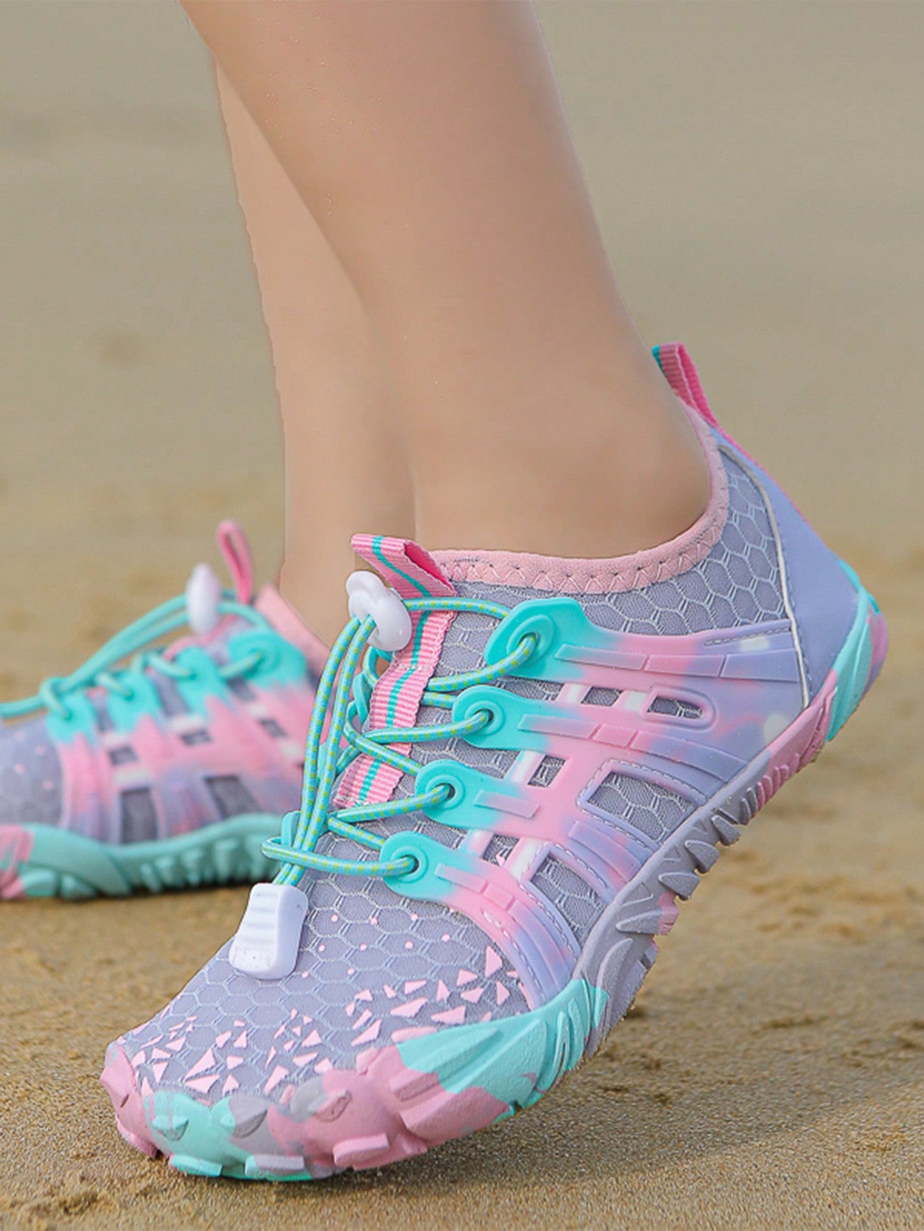 Girls purple quick-drying water shoes featuring a geometric pattern, slip-on fit with lace-up detail, and rubber outsole.