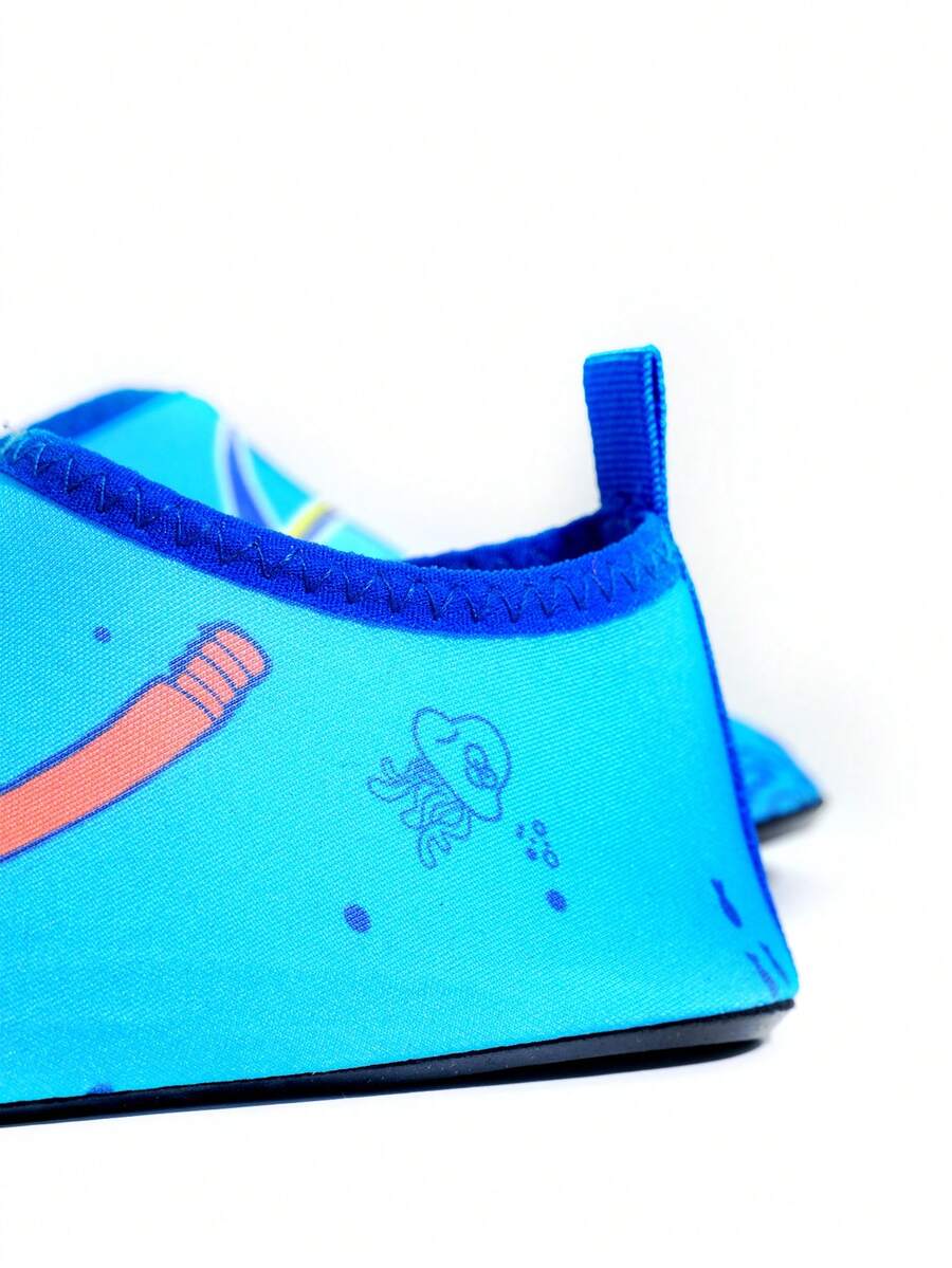 Multicolor cartoon pattern boys' aqua socks with breathable polyester upper, slip-on closure, and non-slip TPR outsole.