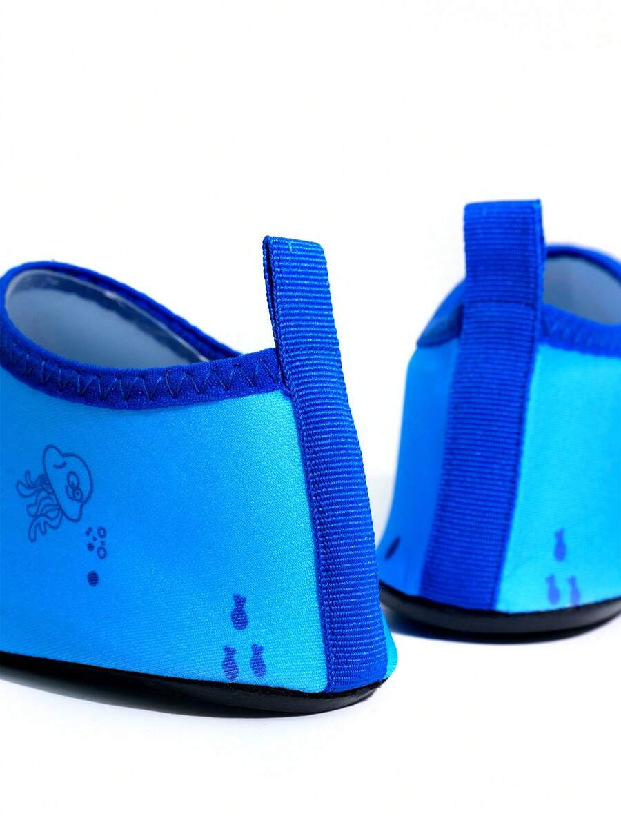 Multicolor cartoon pattern boys' aqua socks with breathable polyester upper, slip-on closure, and non-slip TPR outsole.