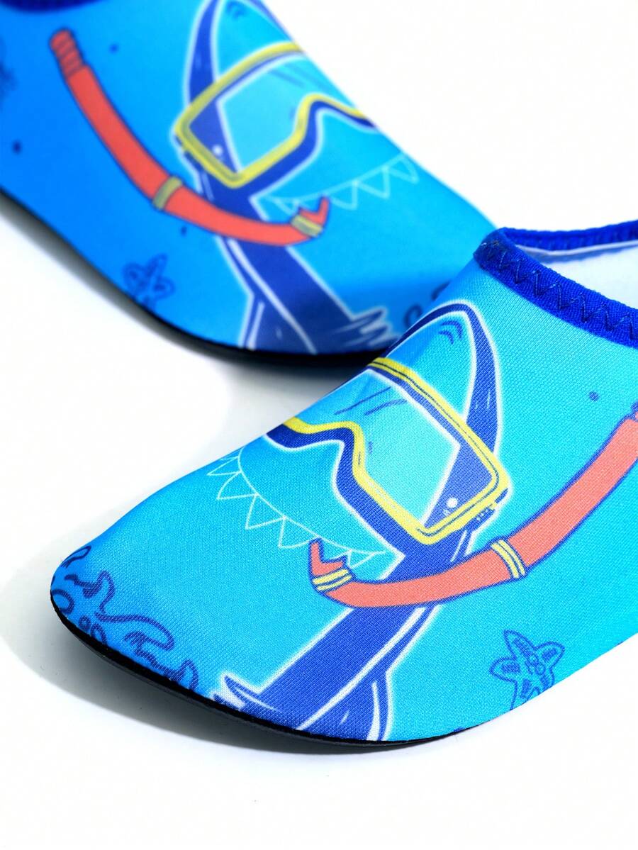 Multicolor cartoon pattern boys' aqua socks with breathable polyester upper, slip-on closure, and non-slip TPR outsole.