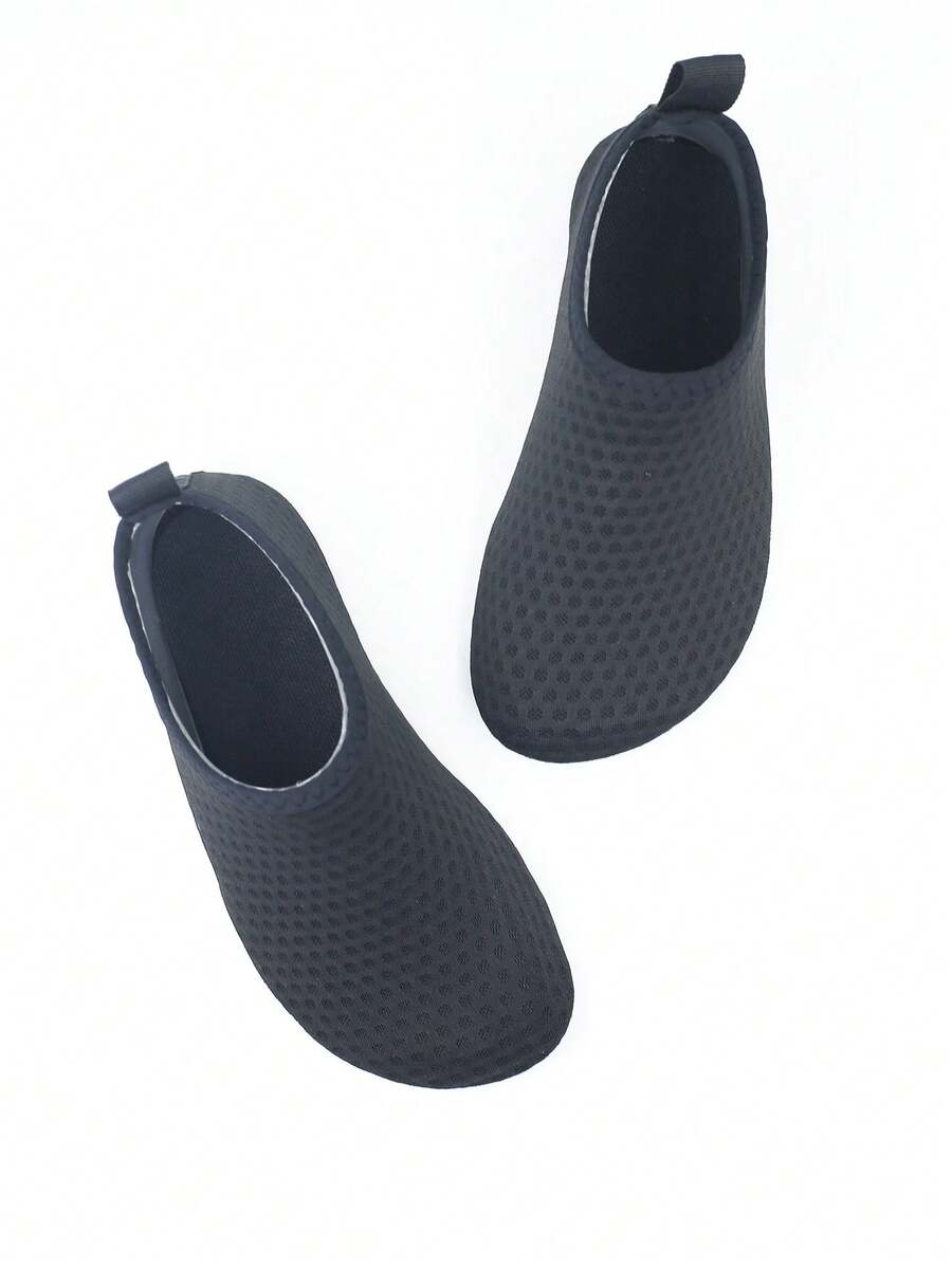 Pair of black kids water shoes with breathable Lycra upper and non-slip rubber sole for boys and girls.