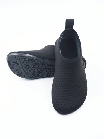 Pair of black kids water shoes with breathable Lycra upper and non-slip rubber sole for boys and girls.