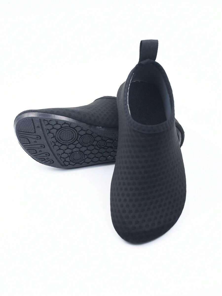 Pair of black kids water shoes with breathable Lycra upper and non-slip rubber sole for boys and girls.