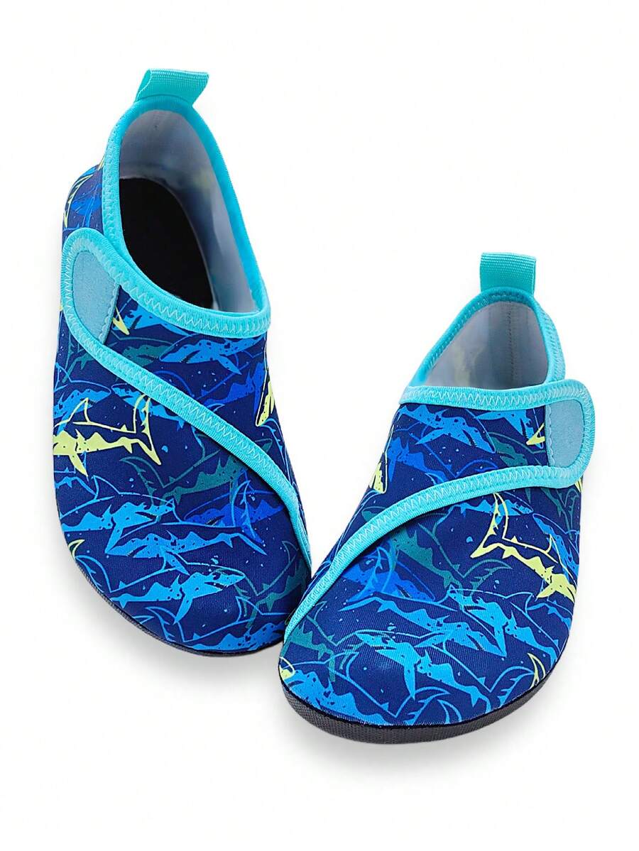 Blue kids water shoes with a shark print pattern, breathable fabric upper, and secure hook and loop closure.