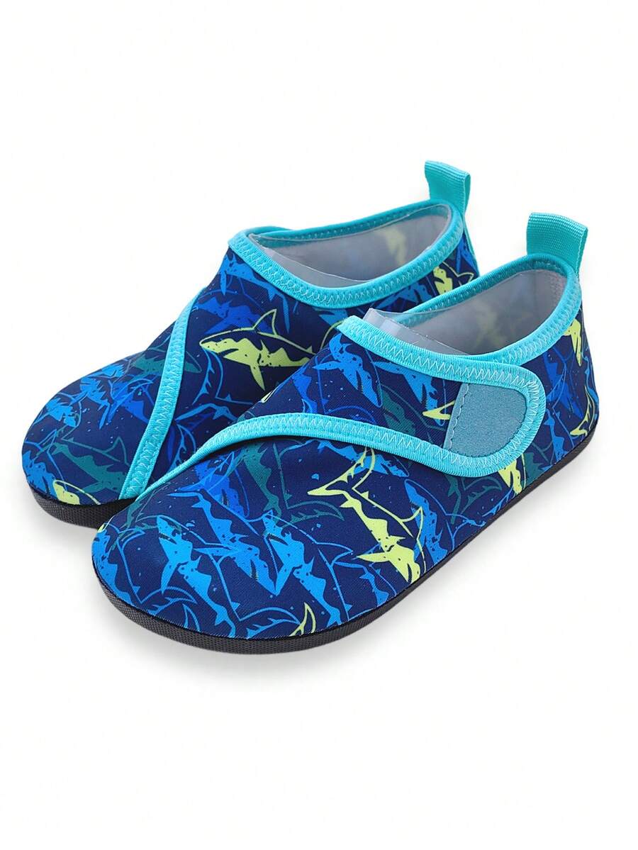 Blue kids water shoes with a shark print pattern, breathable fabric upper, and secure hook and loop closure.