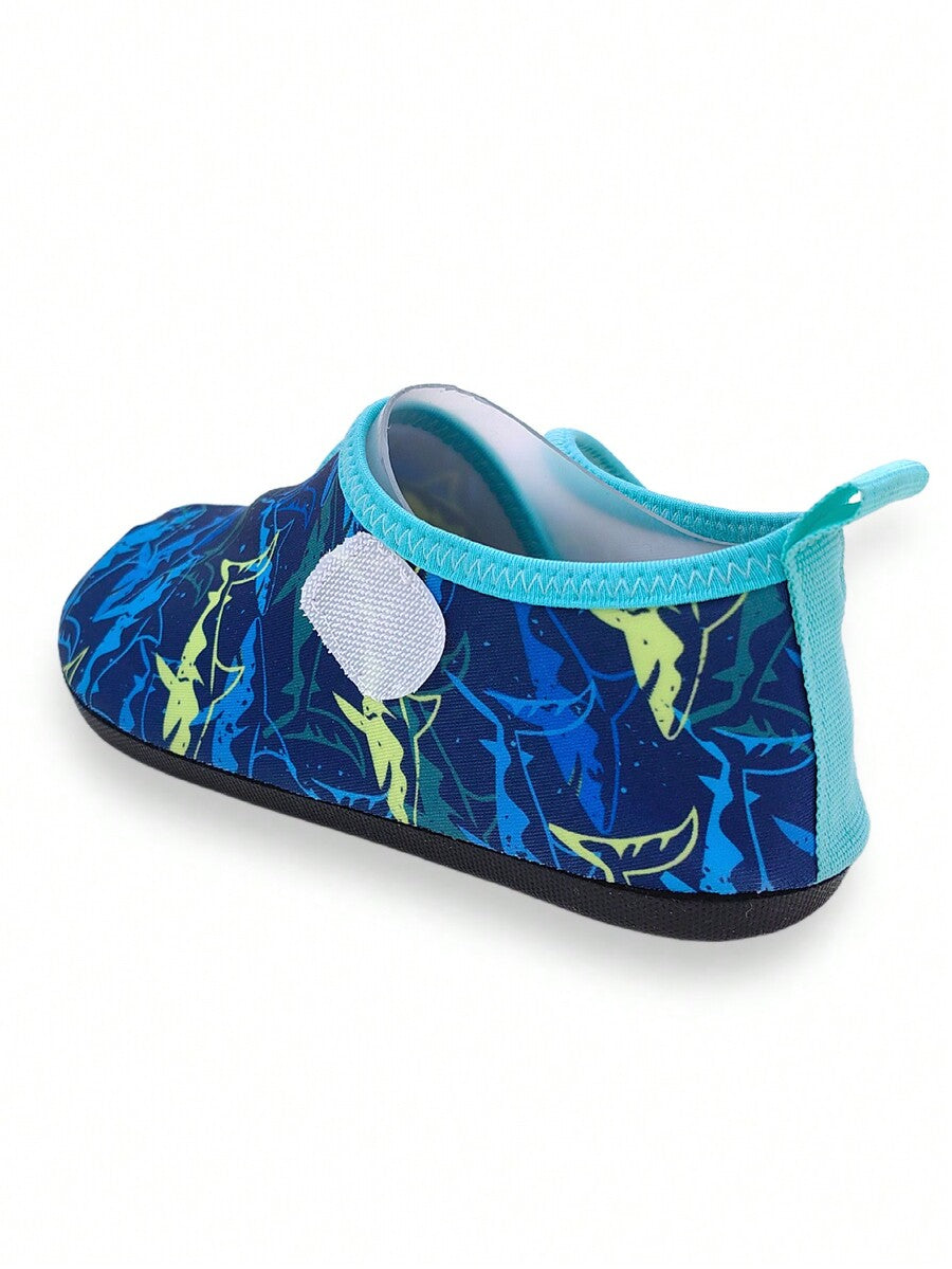 Blue kids water shoes with a shark print pattern, breathable fabric upper, and secure hook and loop closure.