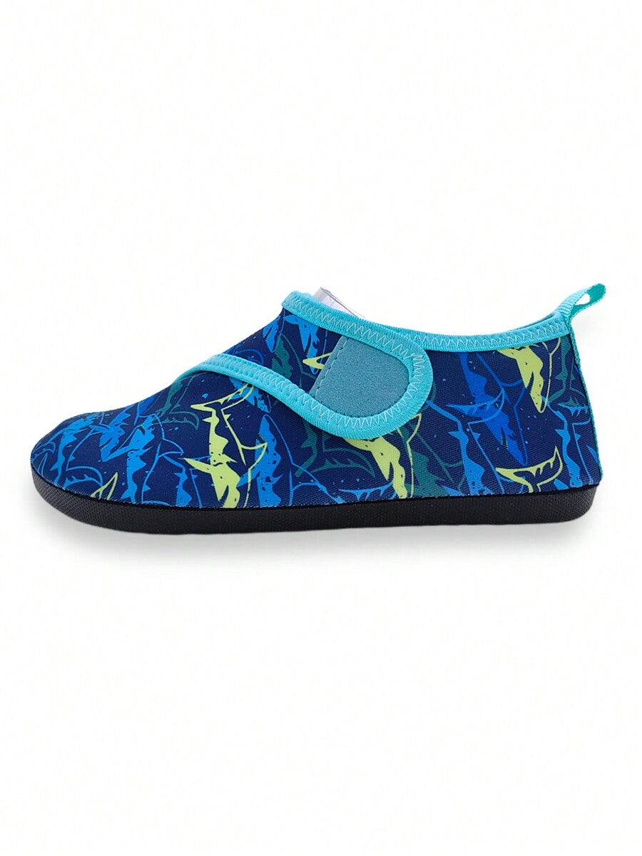 Blue kids water shoes with a shark print pattern, breathable fabric upper, and secure hook and loop closure.