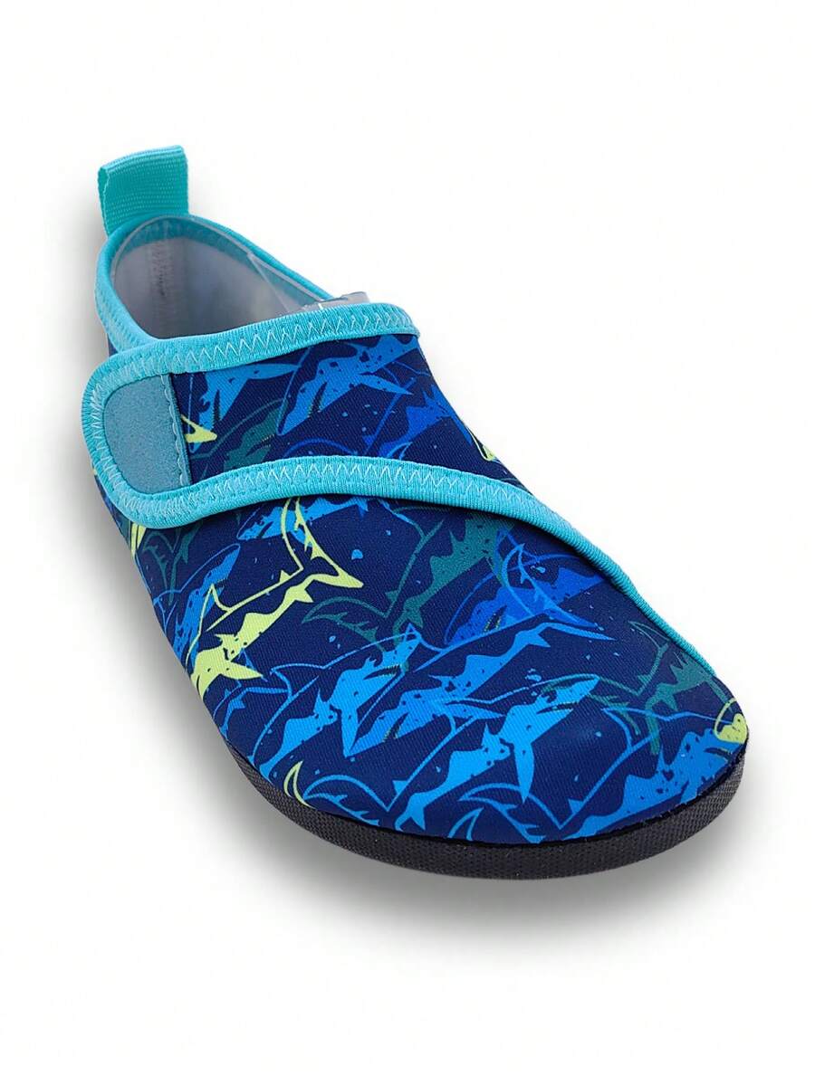 Blue kids water shoes with a shark print pattern, breathable fabric upper, and secure hook and loop closure.