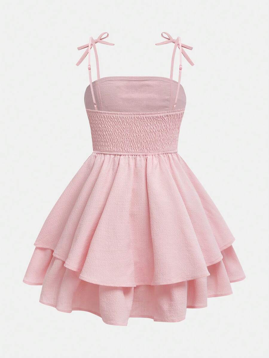 Tween girls apricot tiered cami dress with spaghetti straps, high waist, and slim fit layered hem.
