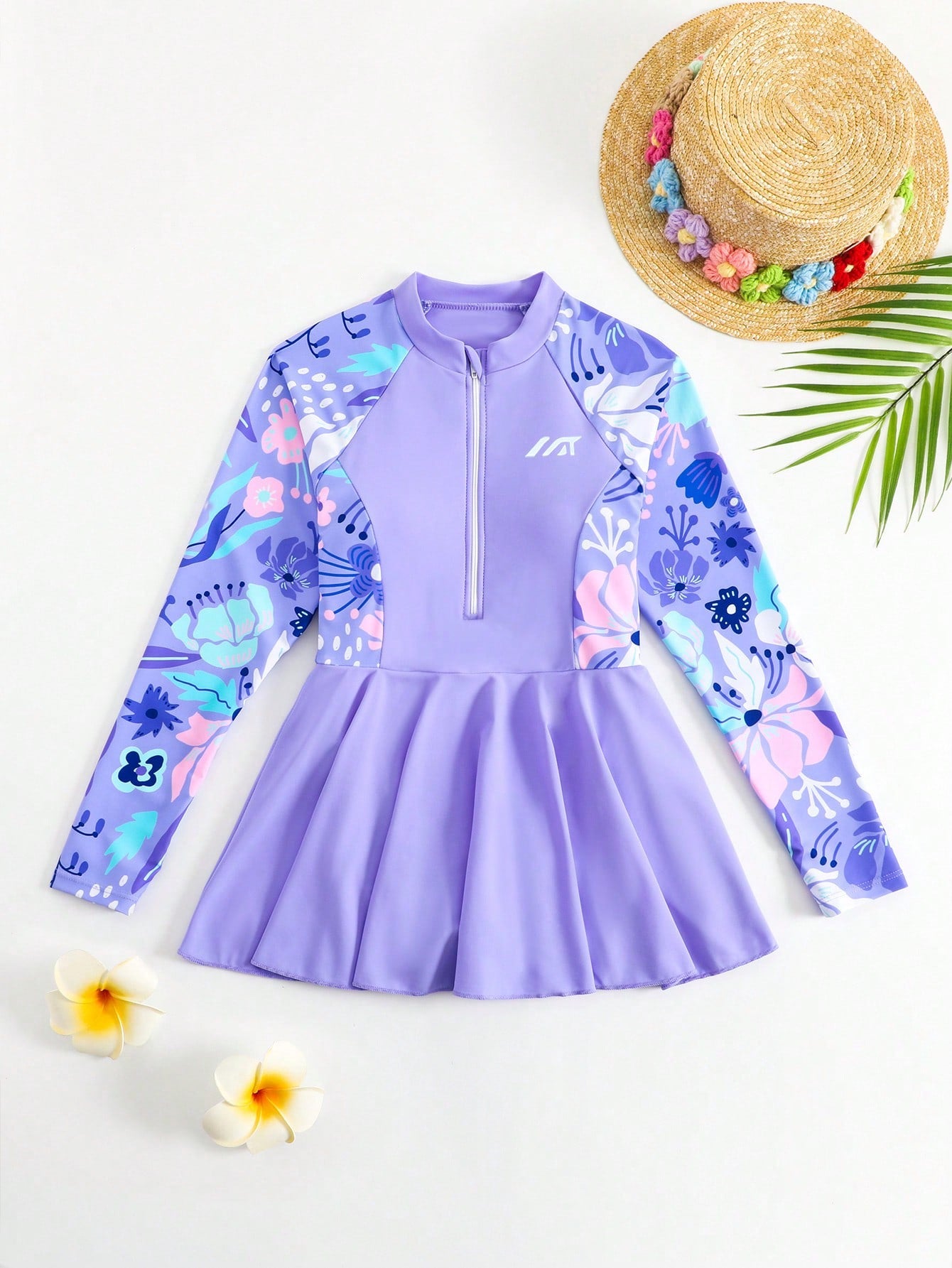 Tween girls one-piece swimsuit in black floral pattern with long sleeves, high neck, front zipper, and a skirt-style bottom.