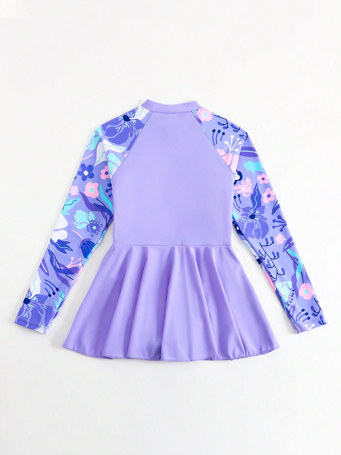 Tween girls one-piece swimsuit in black floral pattern with long sleeves, high neck, front zipper, and a skirt-style bottom.