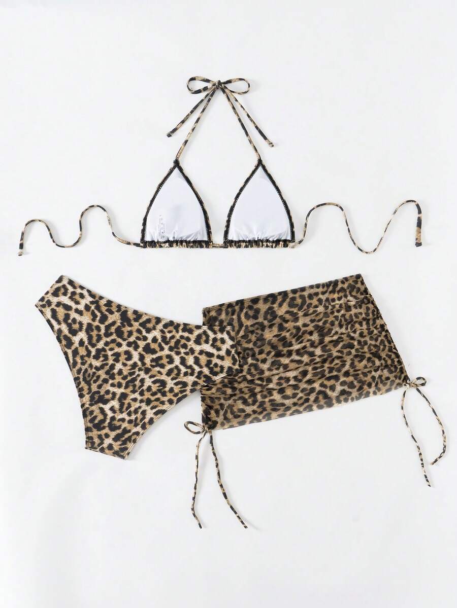 Women's black 3-piece bikini set featuring a halter triangle top with removable padding, high-waisted bottoms, and a knee-length mesh skirt with tie details.