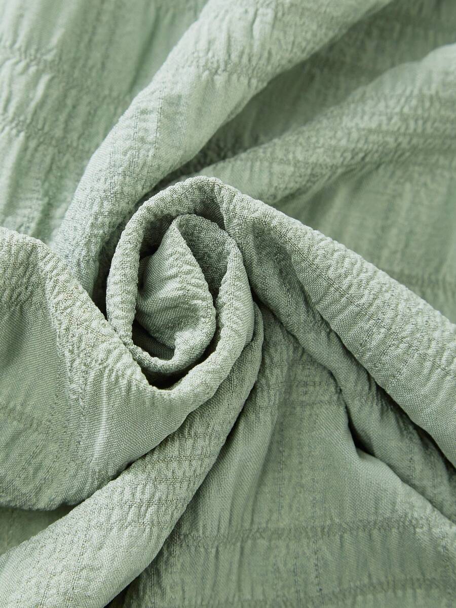 Tween girl wearing an Army Green textured short sleeve smock midi dress with round neck and ruffle flounce hem.