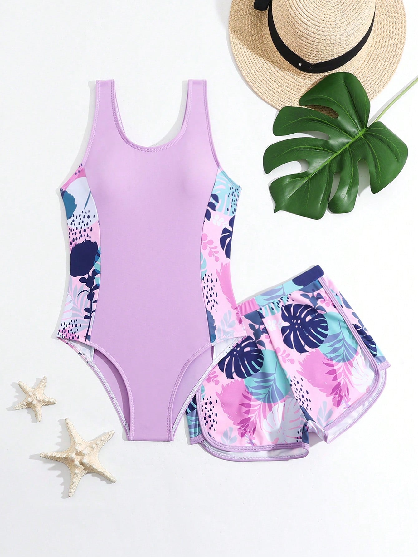 Tween girls 2-piece swimsuit set with a printed one-piece featuring ruffle trim, scoop neckline, cut-out detail, and matching shorts bottom.