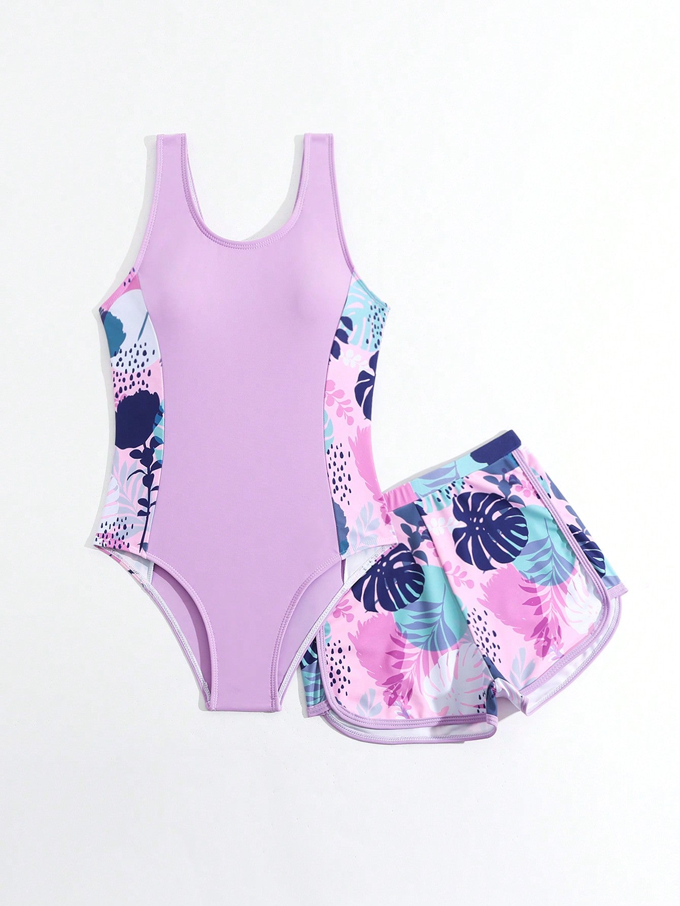 Tween girls 2-piece swimsuit set with a printed one-piece featuring ruffle trim, scoop neckline, cut-out detail, and matching shorts bottom.