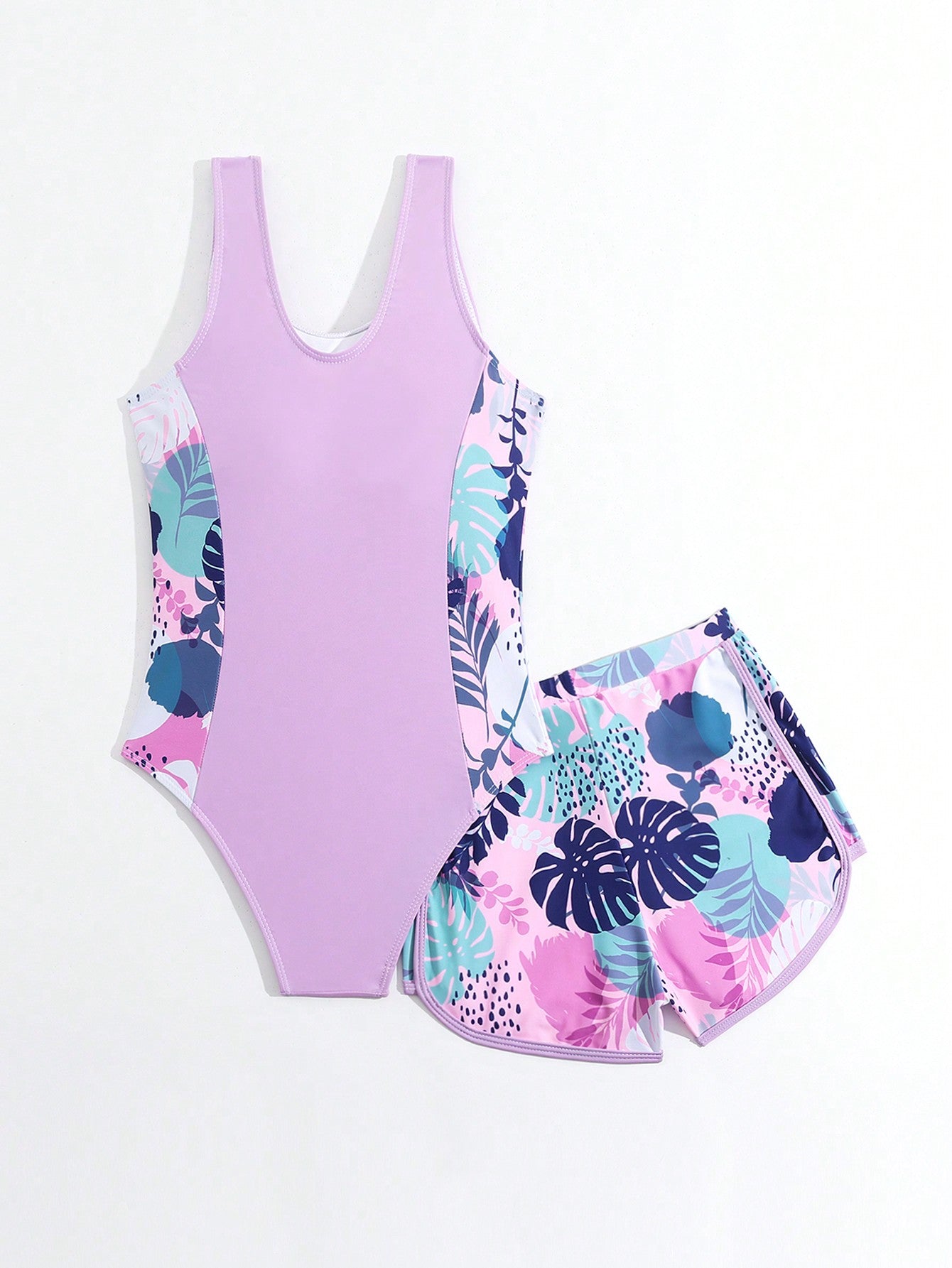 Tween girls 2-piece swimsuit set with a printed one-piece featuring ruffle trim, scoop neckline, cut-out detail, and matching shorts bottom.