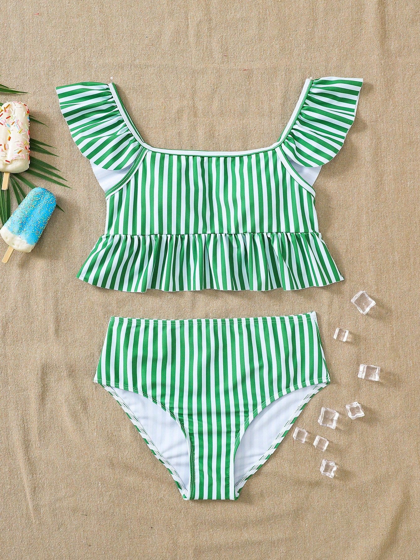 Girls striped tankini swimwear set with ruffle detail, square neckline, wireless top, and high-waist lined bottoms for beach and vacation wear.