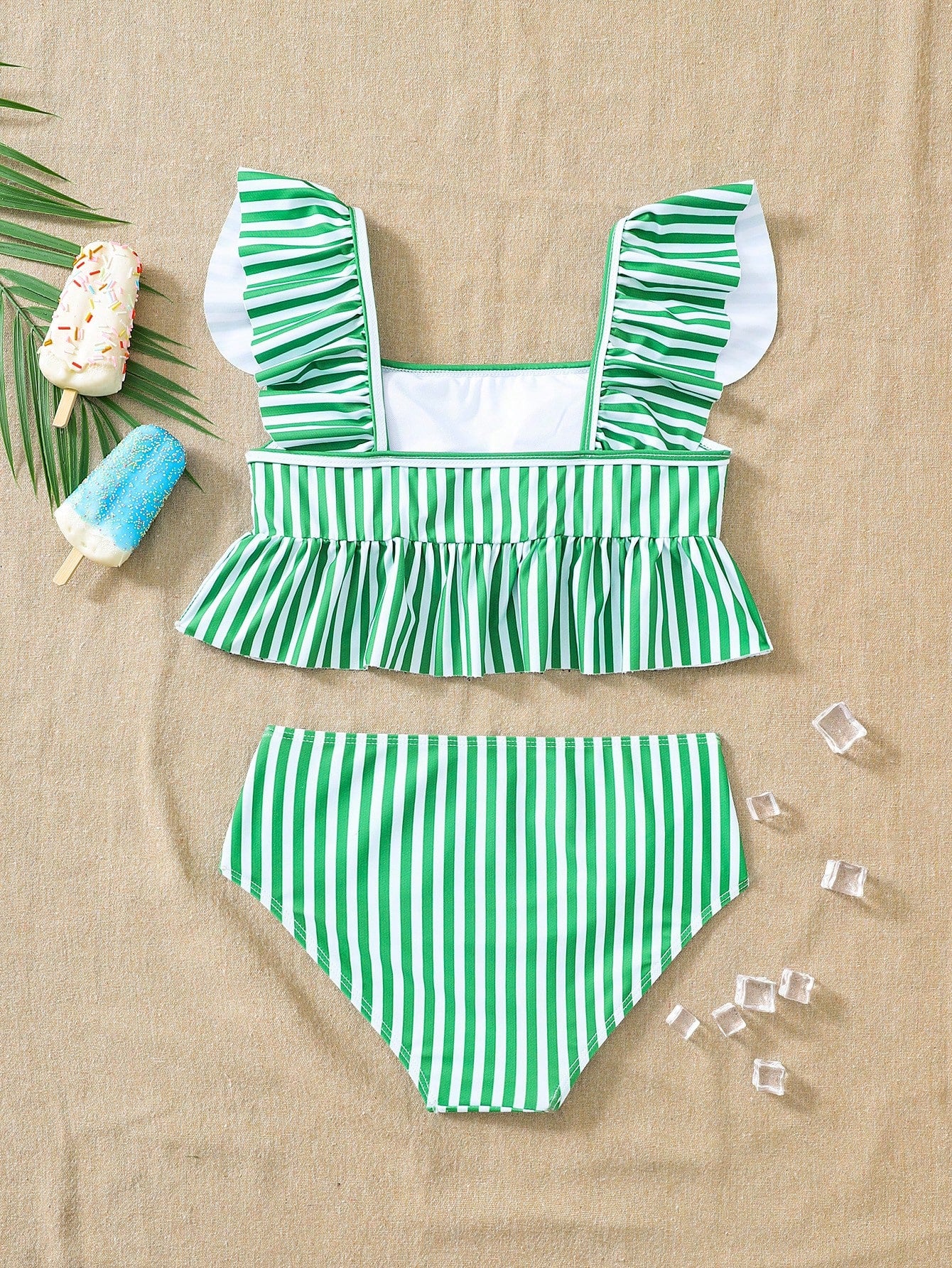 Girls striped tankini swimwear set with ruffle detail, square neckline, wireless top, and high-waist lined bottoms for beach and vacation wear.