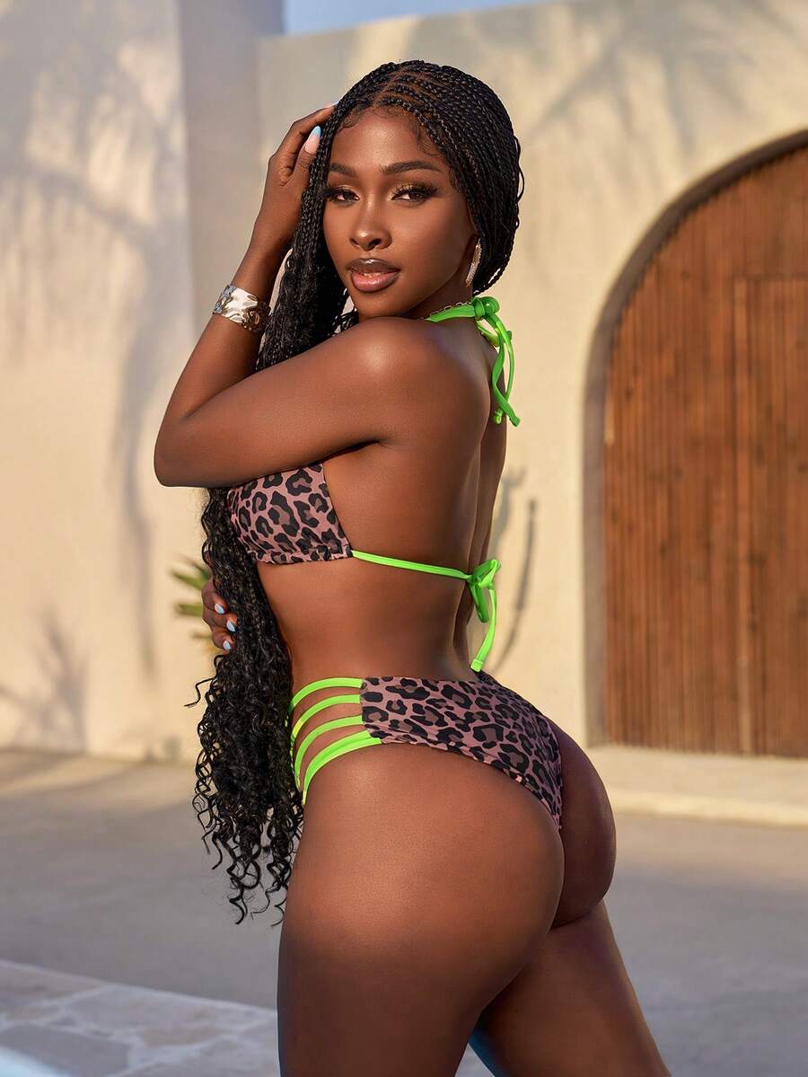 Women's leopard print bikini set featuring a halter push-up top and high-waisted cut out bottoms with tie back detail.