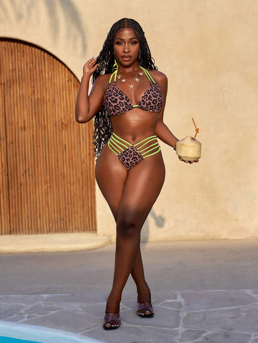 Women's leopard print bikini set featuring a halter push-up top and high-waisted cut out bottoms with tie back detail.