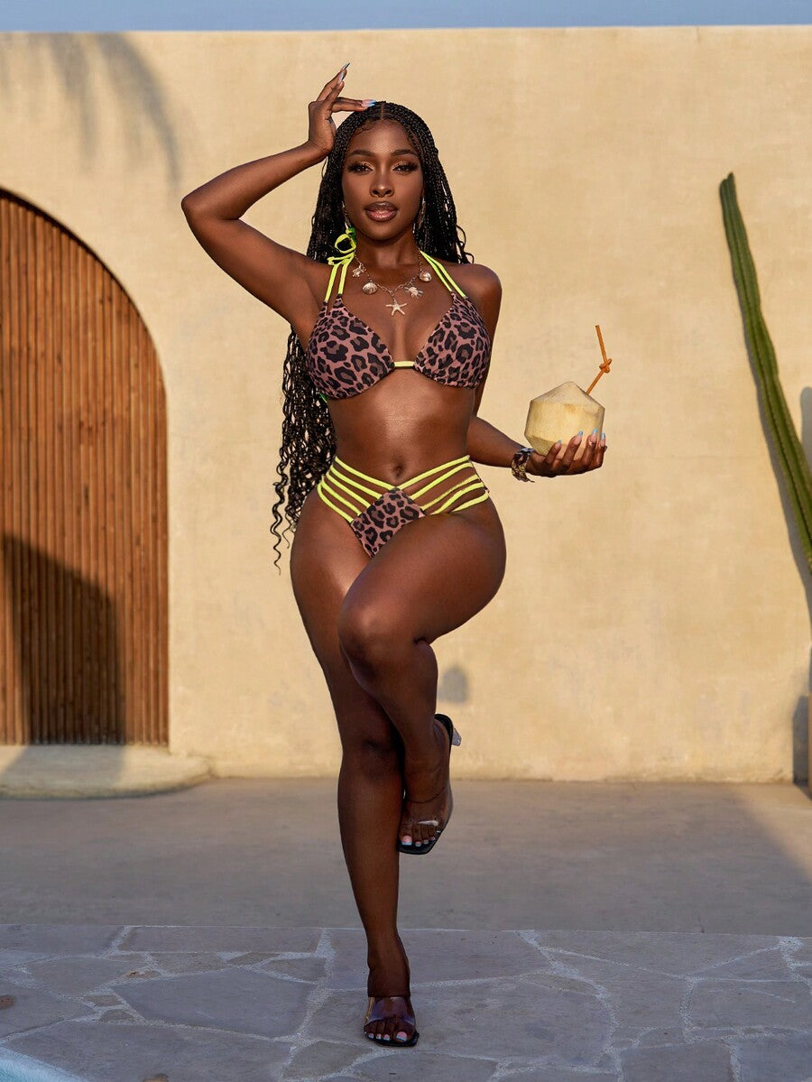 Women's leopard print bikini set featuring a halter push-up top and high-waisted cut out bottoms with tie back detail.