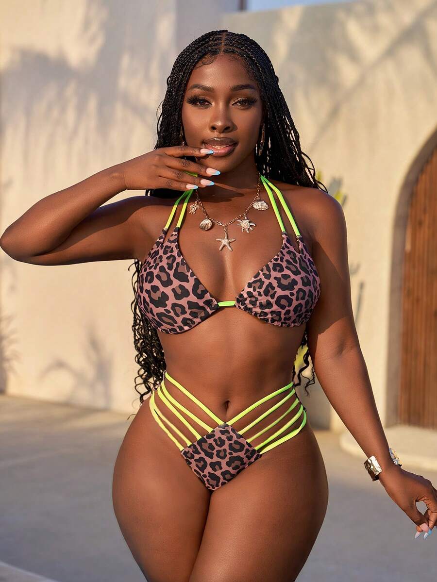 Women's leopard print bikini set featuring a halter push-up top and high-waisted cut out bottoms with tie back detail.