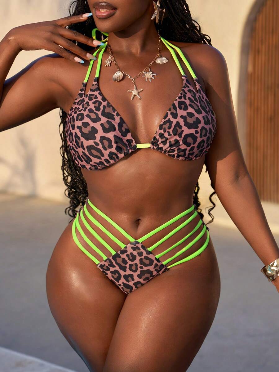 Women's leopard print bikini set featuring a halter push-up top and high-waisted cut out bottoms with tie back detail.