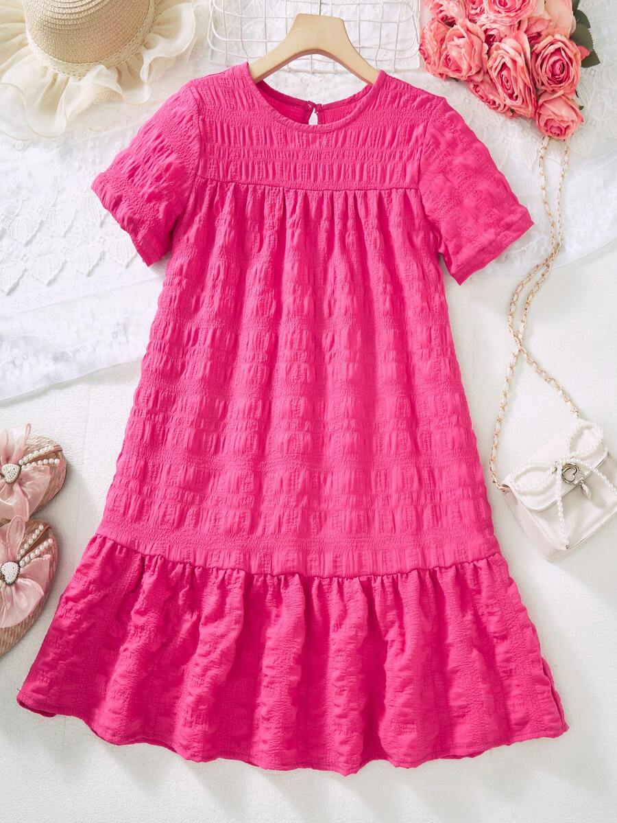 Tween girl wearing an Army Green textured short sleeve smock midi dress with round neck and ruffle flounce hem.