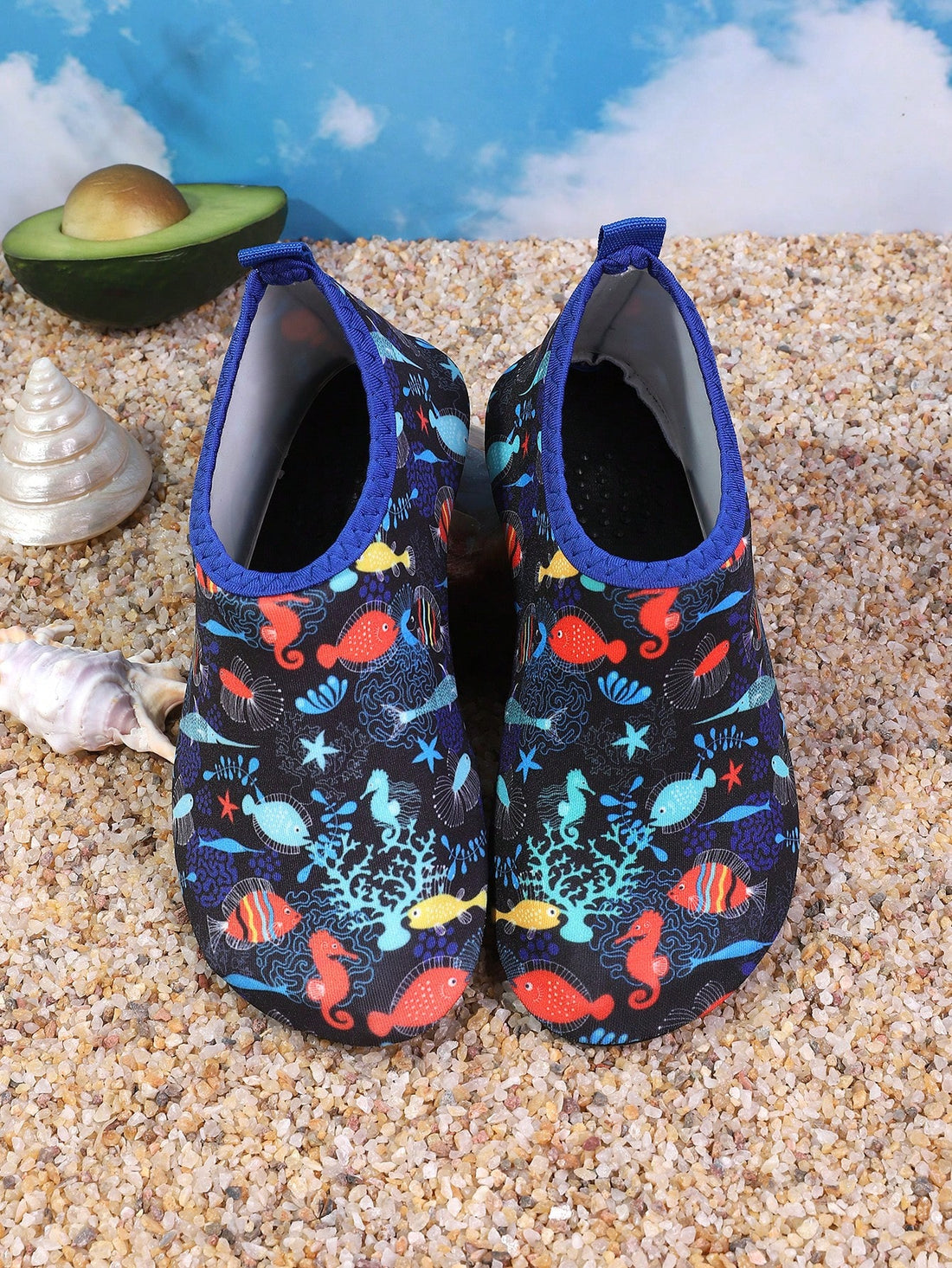 Pair of lightweight slip-on kids water shoes with breathable upper and non-slip outsole for summer beach and pool wear.