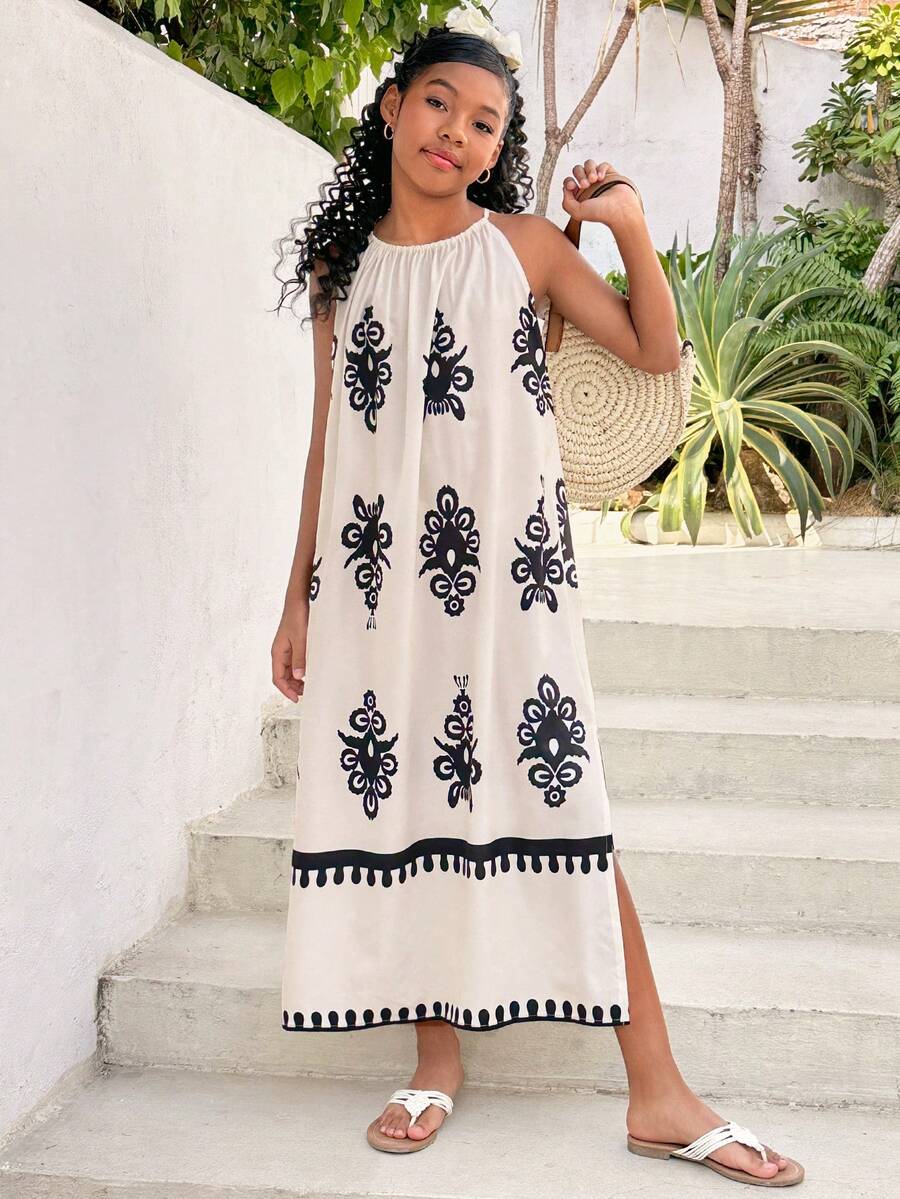 Tween girls green floral print cami dress with halter neckline, sleeveless cut, zipper detail, flared hem, and long vacation style silhouette.