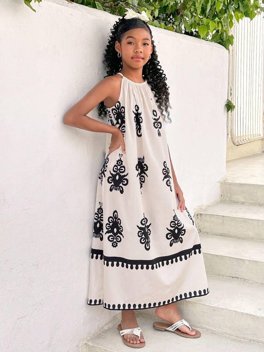 Tween girls green floral print cami dress with halter neckline, sleeveless cut, zipper detail, flared hem, and long vacation style silhouette.