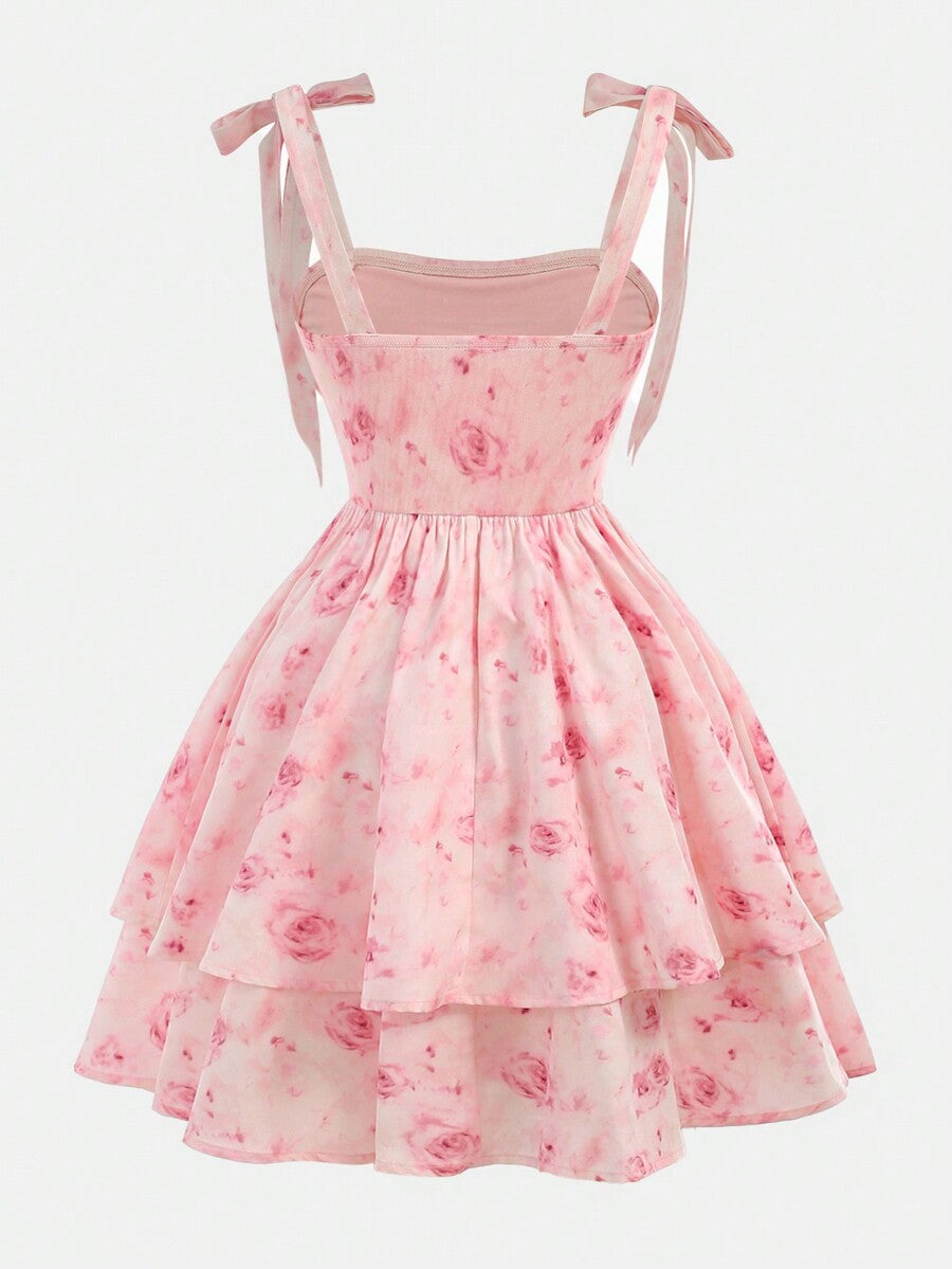 Tween girl wearing a pink tiered off-the-shoulder midi dress with shirred high waist and layered hem