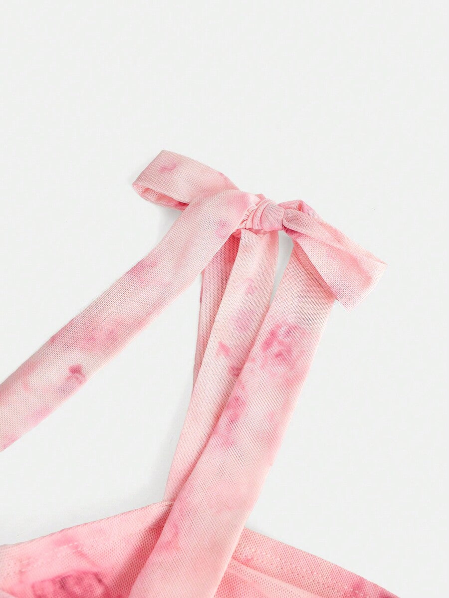 Tween girl wearing a pink tiered off-the-shoulder midi dress with shirred high waist and layered hem