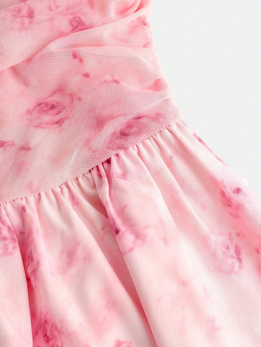 Tween girl wearing a pink tiered off-the-shoulder midi dress with shirred high waist and layered hem