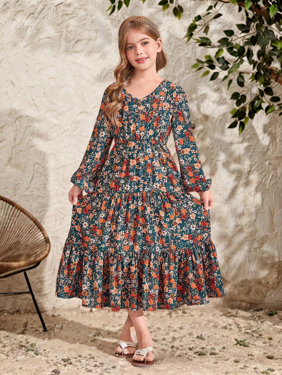 Tween girl wearing an apricot ditsy floral V-neck midi dress with long bishop puff sleeves, tiered ruffle layers, and a flounce hem.