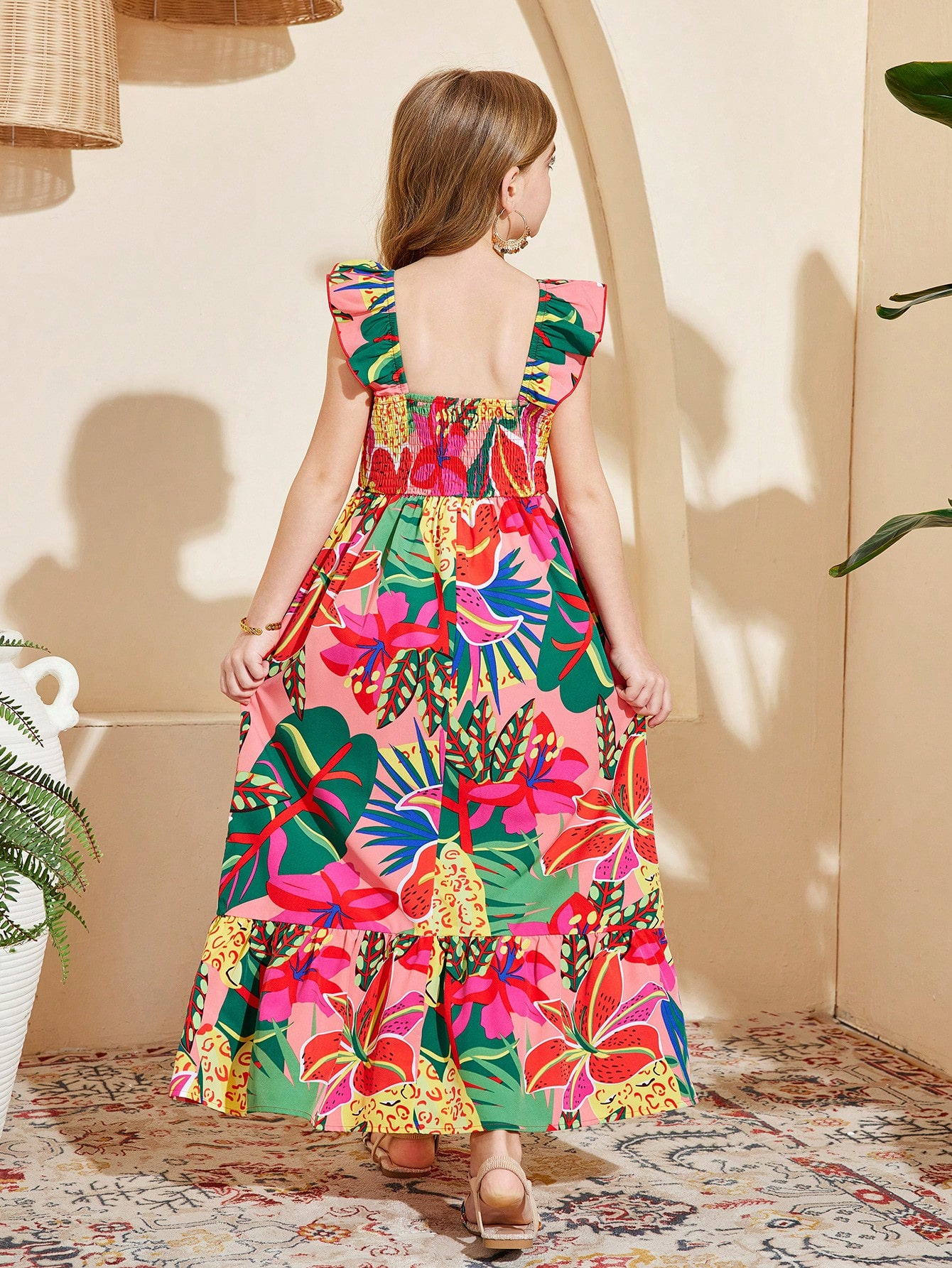 Tween girl multicolor floral vacation dress with square neck, ruffle details, shirred bodice, sleeveless A-line shape, high waist, and flounce hem.