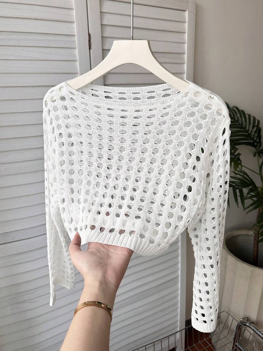 White tween girls beach cover up with cut out details, boat neckline, long bell sleeves, regular length knitwear design, and medium stretch viscose fabric.