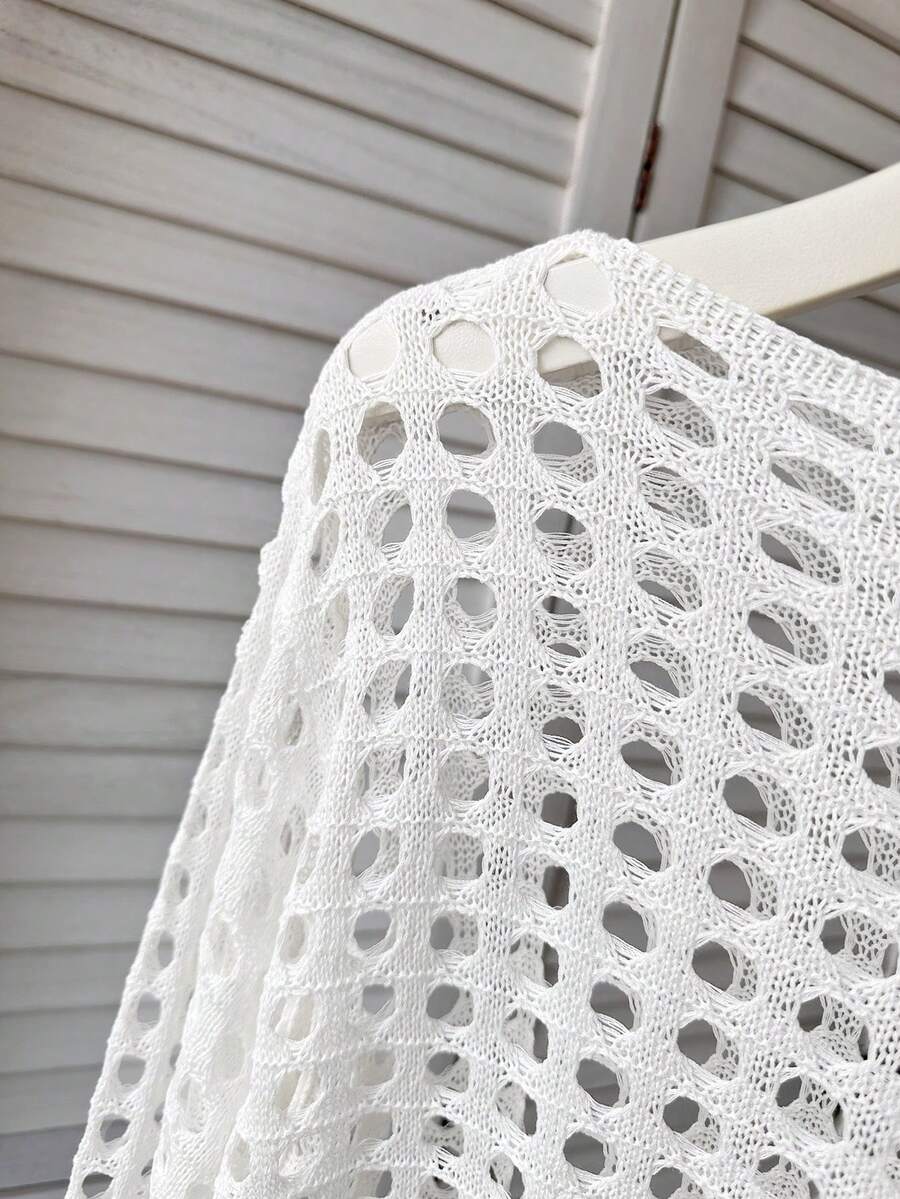White tween girls beach cover up with cut out details, boat neckline, long bell sleeves, regular length knitwear design, and medium stretch viscose fabric.