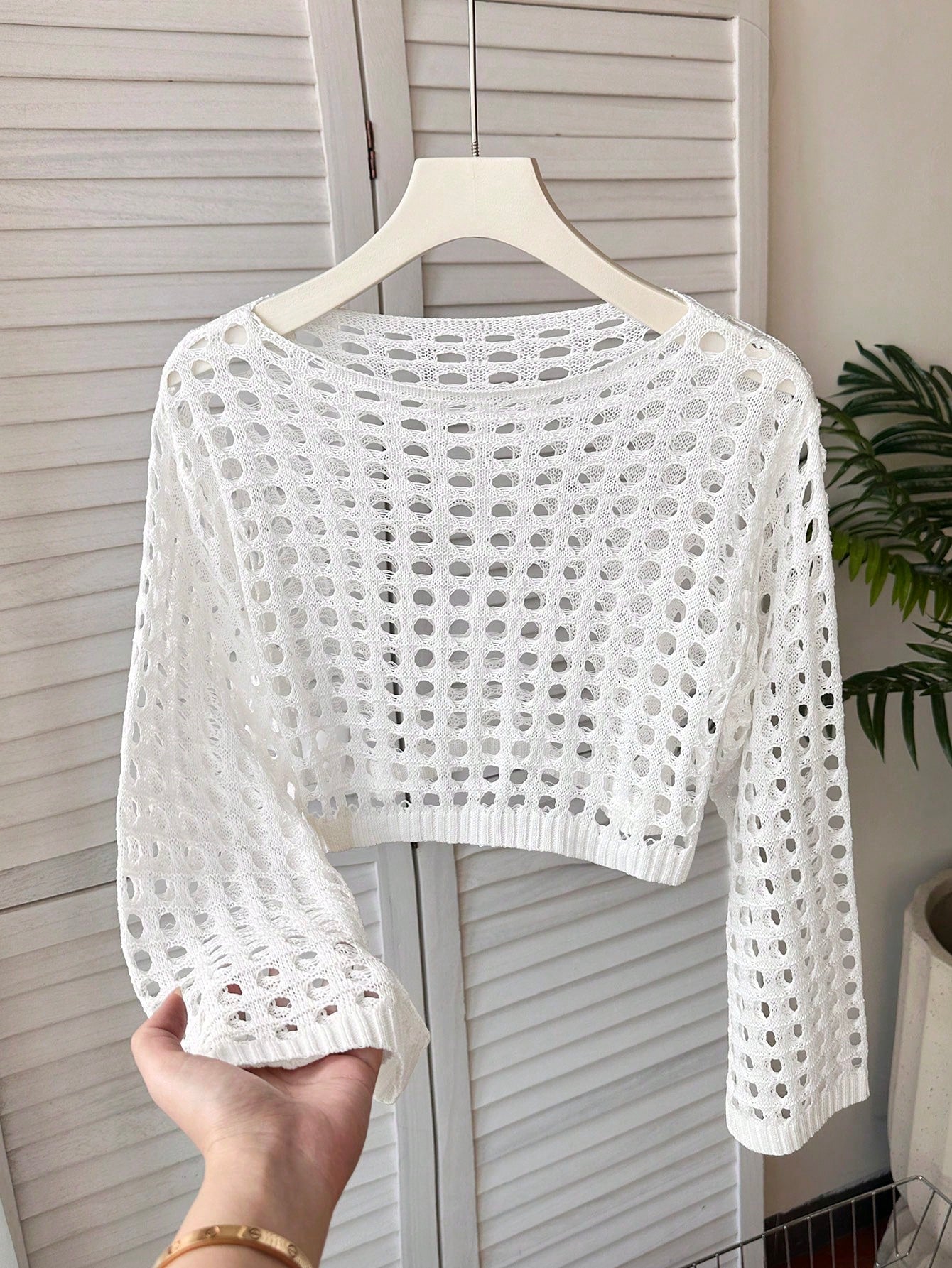 White tween girls beach cover up with cut out details, boat neckline, long bell sleeves, regular length knitwear design, and medium stretch viscose fabric.