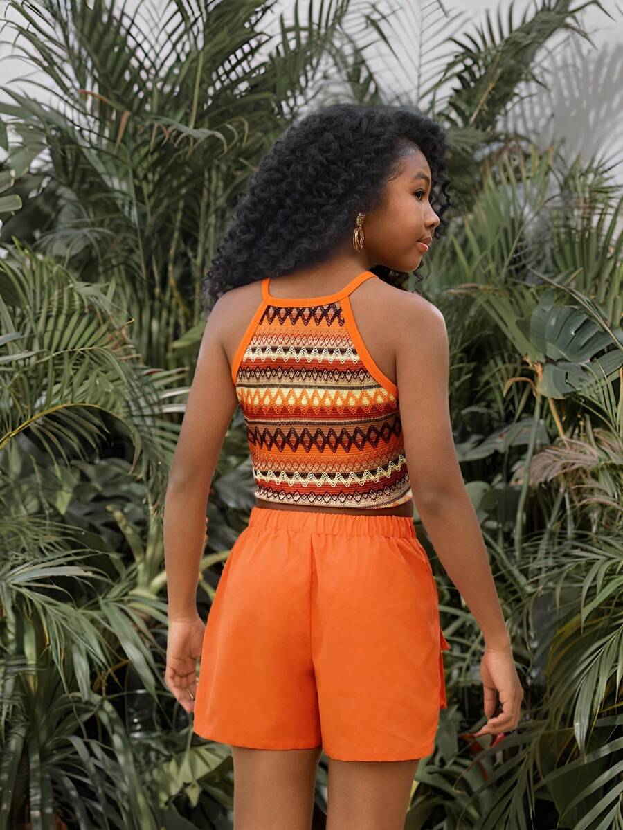 Girls 2-piece vacation outfit set with sleeveless halter knit crop top and graphic cargo shorts.