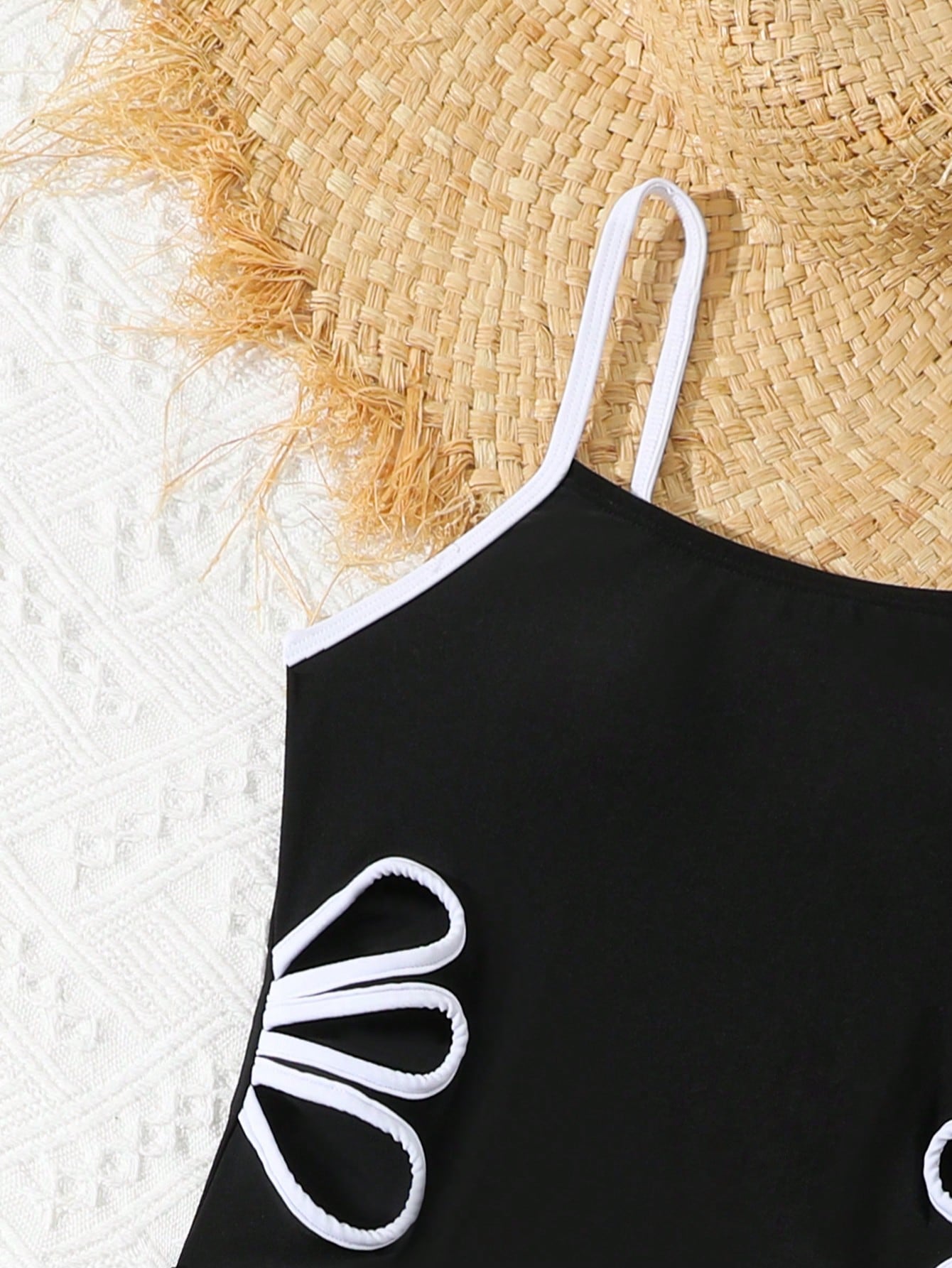 Tween girls black two-piece tankini swimwear set featuring a spaghetti strap sleeveless top with cutout detail and contrast piping, paired with short swim shorts.