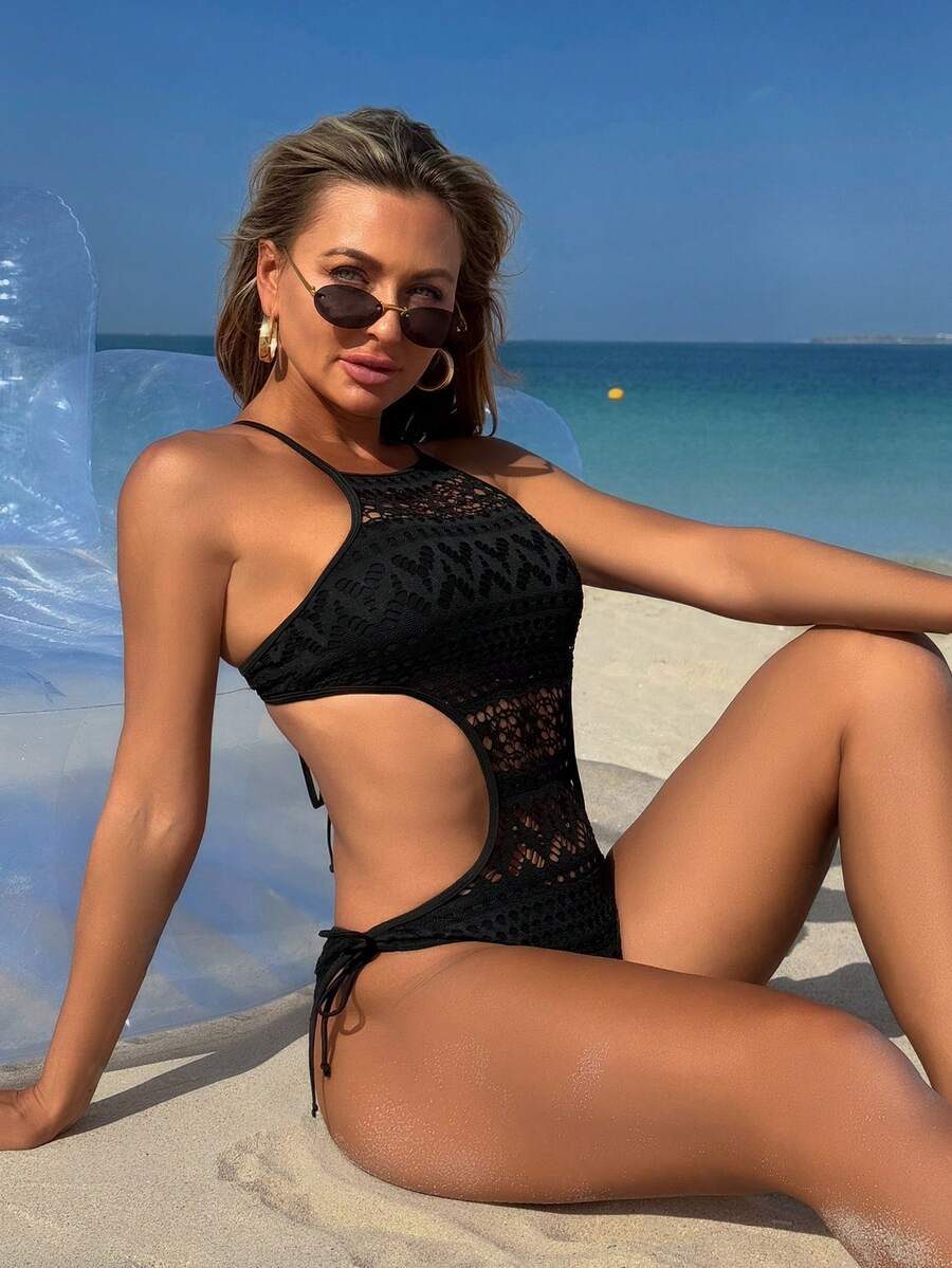 Black boho one-piece swimsuit featuring a scoop neck, backless cut, and side tie details