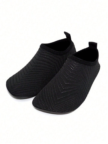 Black breathable slip-on aqua socks for boys featuring polyester material and TPR outsole.
