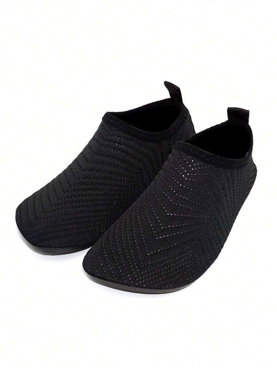 Black breathable slip-on aqua socks for boys featuring polyester material and TPR outsole.