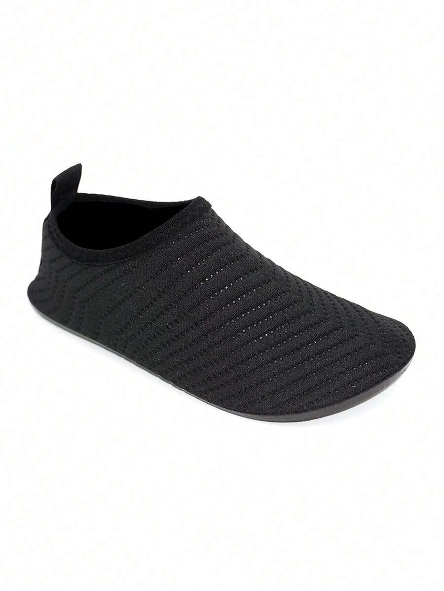 Black breathable slip-on aqua socks for boys featuring polyester material and TPR outsole.